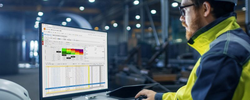 engineer sitting at his desk using rbi matrix in plant ims cenosco on his computer