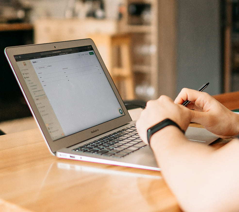 a man working at the desk with a laptop