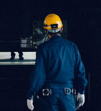 a worker in blue uniform with yellow security helmet, cenosco